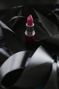 Pink lipstick on black silk background, luxury make-up and beauty cosmetic Royalty Free Stock Photo