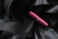 Pink lipstick on black silk background, luxury make-up and beauty cosmetic Royalty Free Stock Photo