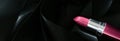 Pink lipstick on black silk background, luxury make-up and beauty cosmetic Royalty Free Stock Photo