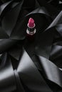 Pink lipstick on black silk background, luxury make-up and beauty cosmetic Royalty Free Stock Photo