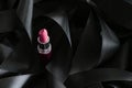 Pink lipstick on black silk background, luxury make-up and beauty cosmetic Royalty Free Stock Photo