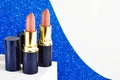 Pink lipstick on a blue shiny background. Gift for a woman. Cosmetic beauty product for festive professional makeup. Copy space, f