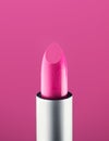 Pink Lipstick close-up, over pink background. Purple color lip stick, closeup. Lip gloss, make-up concept Royalty Free Stock Photo