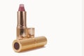 Pink lipstick in golden luxury package.