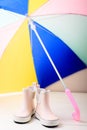 Pink little children rubber boots with colorful umbrella Royalty Free Stock Photo