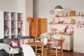 Pink living room and kitchen. Studio apartment. Loft interior. Shelves and spring decor in room. Rent and delivery of housing. Royalty Free Stock Photo