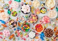 Pink lollipop candies in jar with various milk chocolate and jelly gums candies on white background with liquorice allsorts and Royalty Free Stock Photo