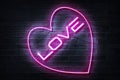 Pink Love Neon Sign on a dark wall