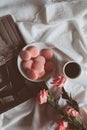 Pink macaron cookies with cup of coffee and rose flowers on white background. Royalty Free Stock Photo