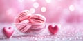 Pink macarons in glass bowl with heart decorations and sparkling background Royalty Free Stock Photo