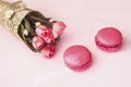 Pink macarons, macaroons, bouquet of flowers, top view. Romantic morning, gift for beloved. Breakfast on Valentin`s