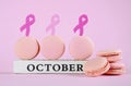 Pink macarons for Pink Ribbon October charity month with symbols.