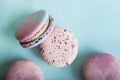 Pink macaroons on blue background close-up and empty space