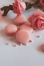 Pink macaroons with bouquet of rose on marble table, pastel colored, Royalty Free Stock Photo