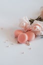 Pink macaroons with bouquet of rose on marble table, pastel colored, Royalty Free Stock Photo