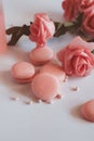 Pink macaroons with bouquet of rose on marble table, pastel colored, Royalty Free Stock Photo