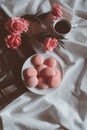 Pink macaroons with coffee cup and pink rose in vintage tone. Royalty Free Stock Photo