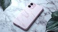 Pink Marble Phone Case Flat Lay on White Marble Surface with Green Leaves Royalty Free Stock Photo