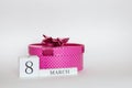 Pink march 8 gift box with a bow on a white background with flower