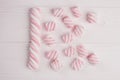Pink marshmallow on wooden background. Royalty Free Stock Photo