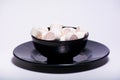Pink marshmellow inside black plate on the white background Royalty Free Stock Photo