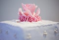 Pink marzipan flower on a white wedding cake