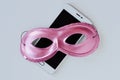 Pink mask on mobile phone - Concept of privacy, security and anonymity of mobile phone for women