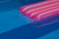 Pink mattress in pool