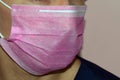 pink medical mask on unknown doctor face
