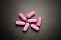 Pink medicine pills on a grey background