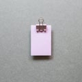 Pink memo paper, sticky notes with binder clip on gray background. top view, copy space Royalty Free Stock Photo