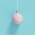 Pink mercury glass Christmas ornament on blue background