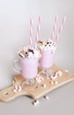 Pink milkshakes or freakshakes with whipped cream, marshmallows, sprinkles