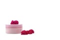 Pink mocap jar for cream, balm, lotion and a small pink-Red roses on a white background. Royalty Free Stock Photo