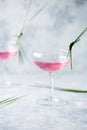 Pink mocktail close up. Beverage with rose and prosecco wine in drinkware. Exotic French Martini cocktail portion with crushed ice Royalty Free Stock Photo
