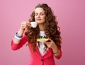 Relaxed modern woman isolated on pink having cup of coffee