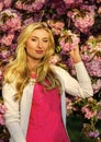 Pink mood. Spring fashion collection. Woman spring flower sakura bloom background. Blonde woman in garden. Gorgeous girl