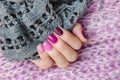 Pink nail design. Beautiful female hand with different shades of pink manicure