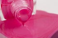 pink nail polish bottle with splatters isolated Royalty Free Stock Photo