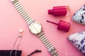 pink nail polish bottle and white pearl necklace and silver watch. Royalty Free Stock Photo