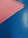 Pink napkin on a blue surface. Background. Royalty Free Stock Photo