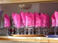 Pink napkins in glasses on tray