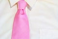 Pink necktie tied on white shirt