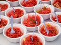 Pink noodles in styrofoam bowls