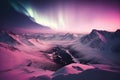 Pink Northern Lights over snowy mountains. Beautiful winter landscape with a valley and a lake. Night magical background. Royalty Free Stock Photo
