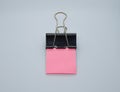 Pink note paper with black binder clip. Binder clip and stack of pink note paper Royalty Free Stock Photo