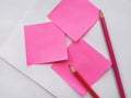 Pink note paper and red pencil on white background Royalty Free Stock Photo