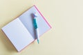 Pink notebook for notes, funny unicorn pen on yellow pastel background. Flat lay. Top view. Copy space Royalty Free Stock Photo
