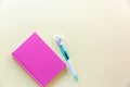 Pink notebook for notes, funny unicorn pen on yellow pastel background. Flat lay. Top view. Copy space Royalty Free Stock Photo