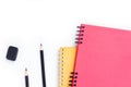 Pink notebook,Yellow notebook,Black pencils and black eraser isolated on white background Royalty Free Stock Photo